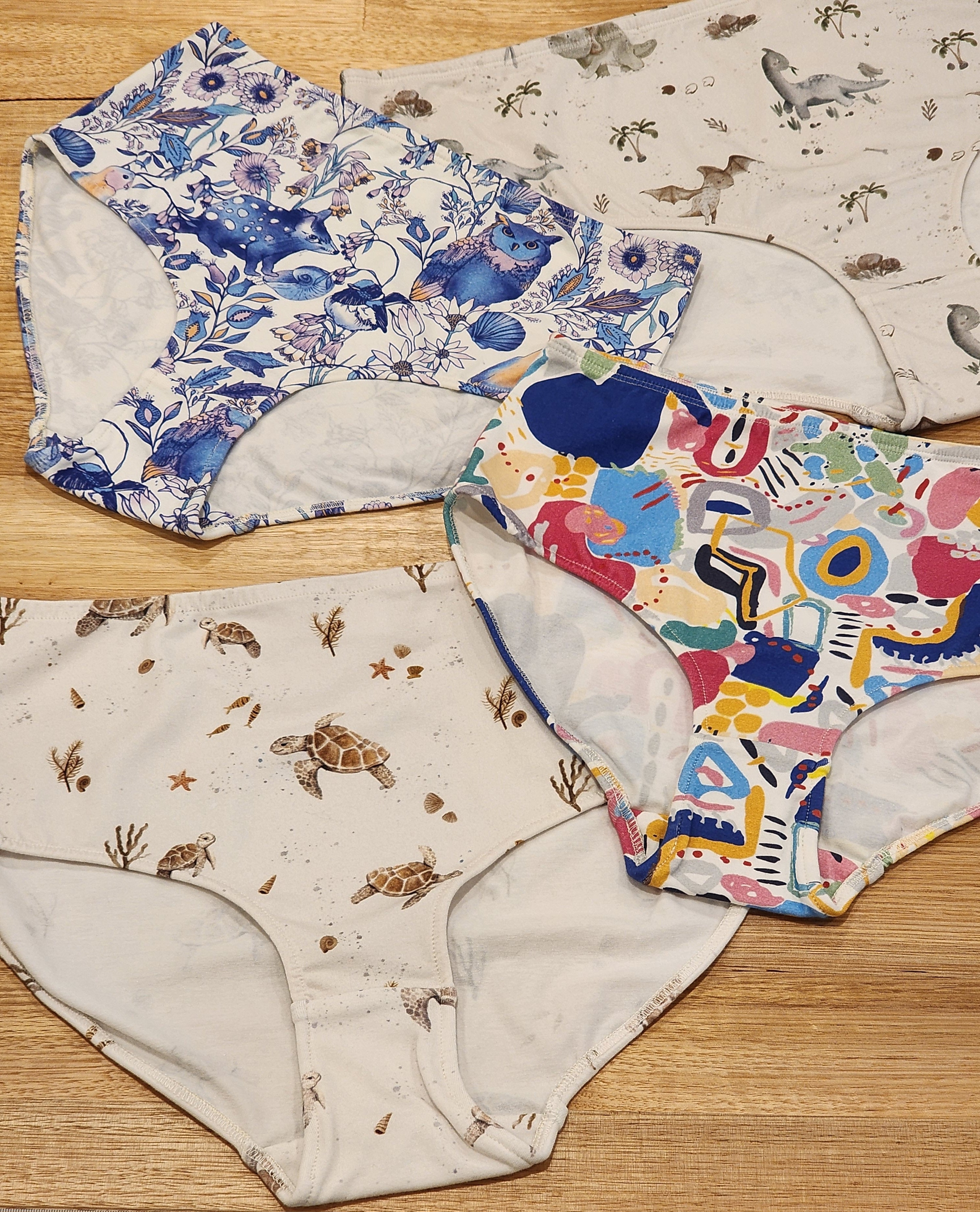 Four pairs of womens high waisted briefs by by Audrey and Grace in four patterns, including Turtles, Owl and Quoll, bright abstract print by Ellen Mckenna and Baby Dinosaurs